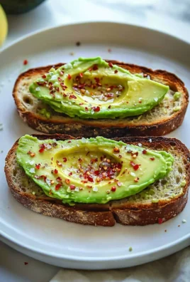 Delicious basic avocado toast topped with ripe avocados on whole grain bread