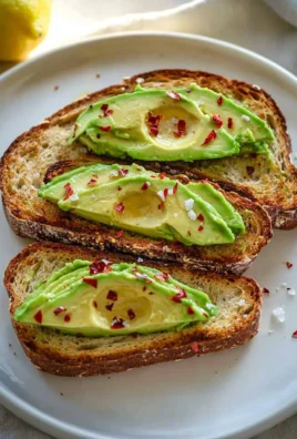 Delicious basic avocado toast topped with seasoning and herbs