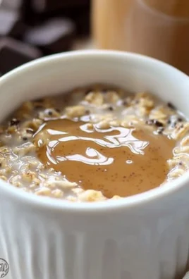 Blended overnight oats in a glass topped with fruits and nuts