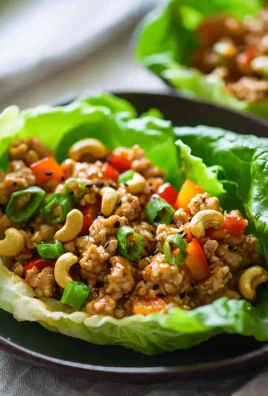 Healthy cashew chicken lettuce wraps served on a plate