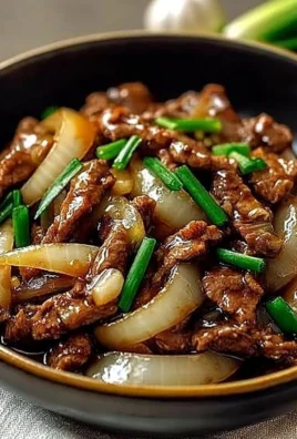Delicious Chinese Beef and Onion Stir Fry served on a plate with vegetables