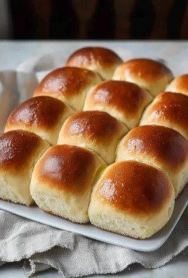 Freshly baked dinner rolls served on a wooden table