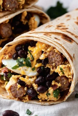 High-protein breakfast burrito with eggs, beans, and vegetables on a plate