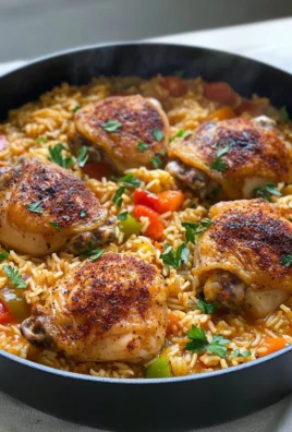 One Pot Cajun Chicken and Rice served in a skillet with vibrant spices and vegetables.