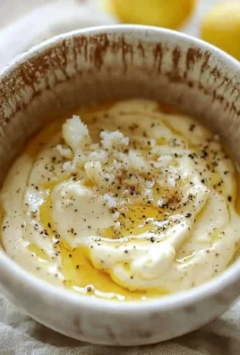 Homemade Original Caesar Salad Dressing in a bowl with ingredients