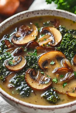 Bowl of wild mushroom soup garnished with caramelized onion and kale.