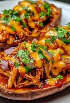 BBQ chicken stuffed sweet potatoes on a plate with toppings