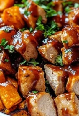 BBQ chicken sweet potato bowl topped with fresh herbs and veggies
