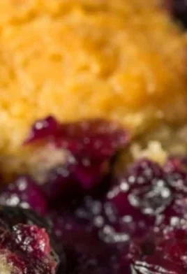 Delicious homemade blackberry cobbler served warm with ice cream.