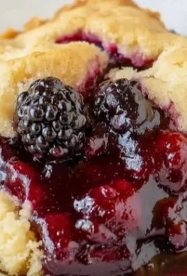 Homemade blackberry cobbler topped with ice cream and fresh blackberries