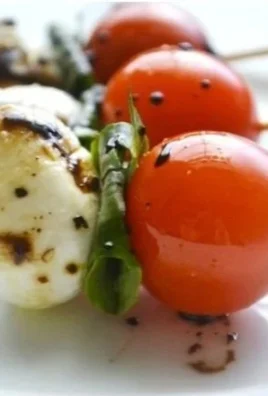 Colorful Caprese Salad Skewers with tomatoes, mozzarella, and basil.