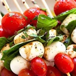 Delicious Caprese Skewers with mozzarella, cherry tomatoes, and basil leaves