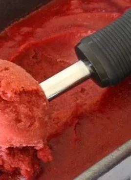 Delicious Cherry Sherbet dessert in a bowl with fresh cherries on top