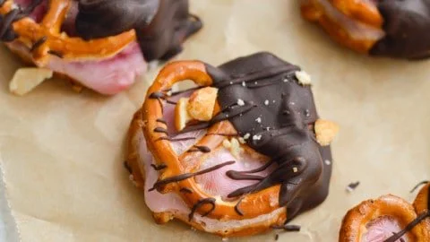 Chocolate dipped strawberry yogurt pretzel bites garnished with sprinkles