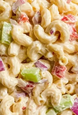 Bowl of classic macaroni salad with vegetables and dressing