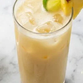 Refreshing Coconut Lime Pineapple Mocktail garnished with lime and pineapple slices
