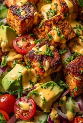 Creamy Bang Bang Salmon Salad served in a bowl with fresh vegetables