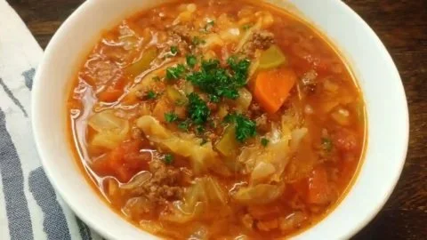 Bowl of Easy Cabbage Roll Soup garnished with fresh herbs