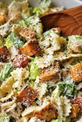 Easy Chicken Caesar Pasta Salad served in a bowl with fresh ingredients.