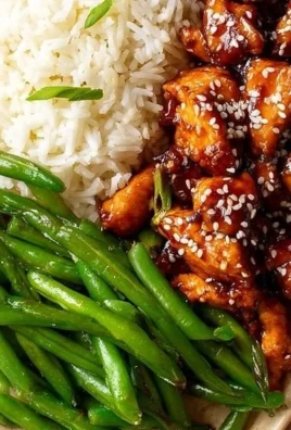 Delicious high protein sesame chicken served with vegetables and rice