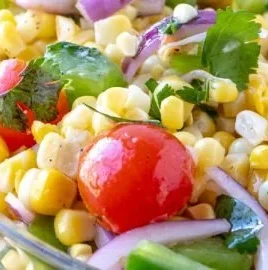 Bowl of Easy Summer Corn Salad with fresh vegetables and dressing