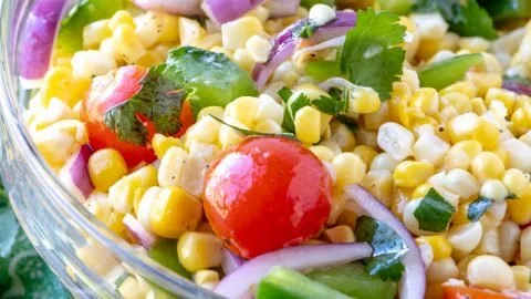 Bowl of Easy Summer Corn Salad with fresh vegetables and dressing