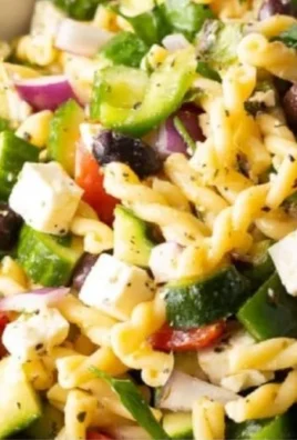 Colorful Greek Pasta Salad with olives, feta, and fresh veggies