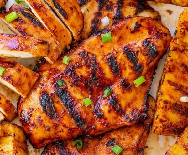 Delicious grilled pineapple chicken served with fresh herbs
