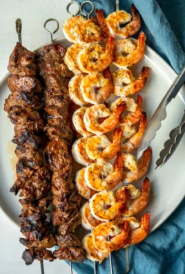 Grilled surf and turf skewers with shrimp and steak on a barbecue grill