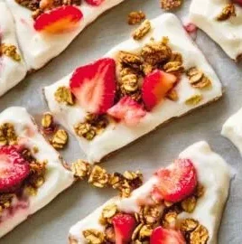 Healthy frozen yogurt bark topped with fresh fruits and nuts