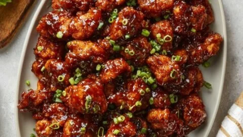 Plate of honey BBQ chicken bites garnished with parsley