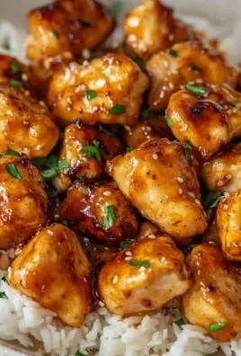Delicious Honey Garlic Chicken Bites served on a plate with dipping sauce.