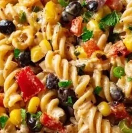 Bowl of high protein Southwest pasta salad with colorful ingredients