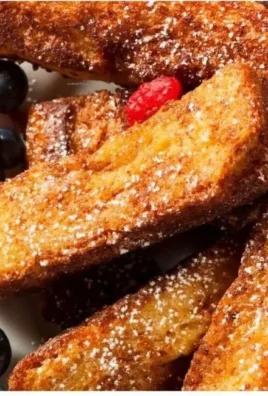 Delicious low calorie high protein French toast sticks served with syrup.