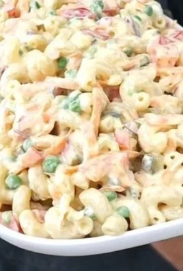 Creamy macaroni salad in a bowl with colorful vegetables