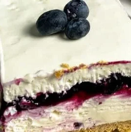 No-bake blueberry cheesecake bars topped with fresh blueberries