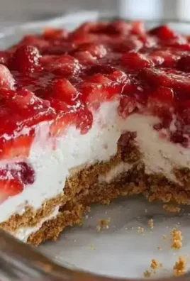 No-Bake Strawberry Cheesecake Lasagna topped with fresh strawberries