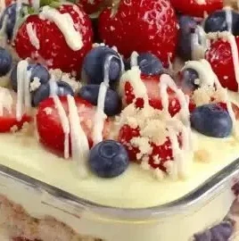 No Bake Summer Berry Icebox Cake topped with fresh berries and whipped cream