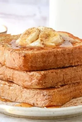 Protein Powder French Toast recipe on a plate with syrup and fresh fruit