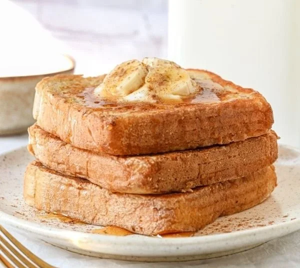 Protein Powder French Toast recipe on a plate with syrup and fresh fruit