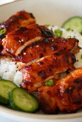 Delicious sticky honey gochujang chicken garnished with sesame seeds.