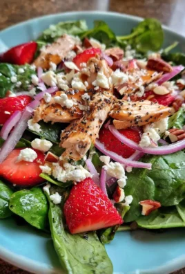 Delicious Strawberry Chicken Spinach Salad with fresh ingredients and vibrant colors.