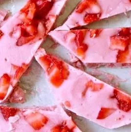 Delicious strawberry frozen yogurt bark topped with fresh strawberries and granola.