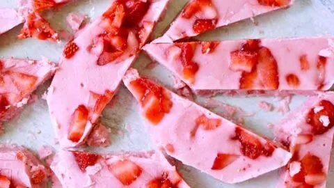 Delicious strawberry frozen yogurt bark topped with fresh strawberries and granola.