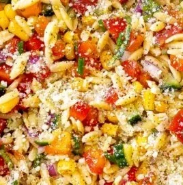 Delicious summer orzo pasta salad with fresh vegetables and herbs