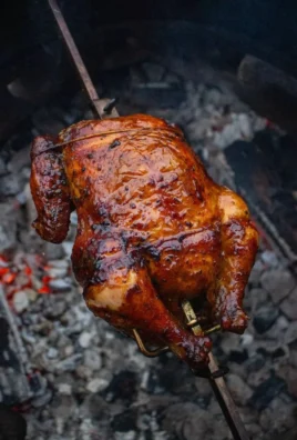 Delicious Tequila Lime Rotisserie Chicken garnished with lime and herbs.