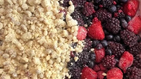 Delicious frozen berry cobbler served in a dish, topped with a golden crisp