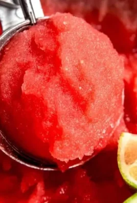Delicious homemade watermelon sorbet served in a bowl with fresh mint leaves