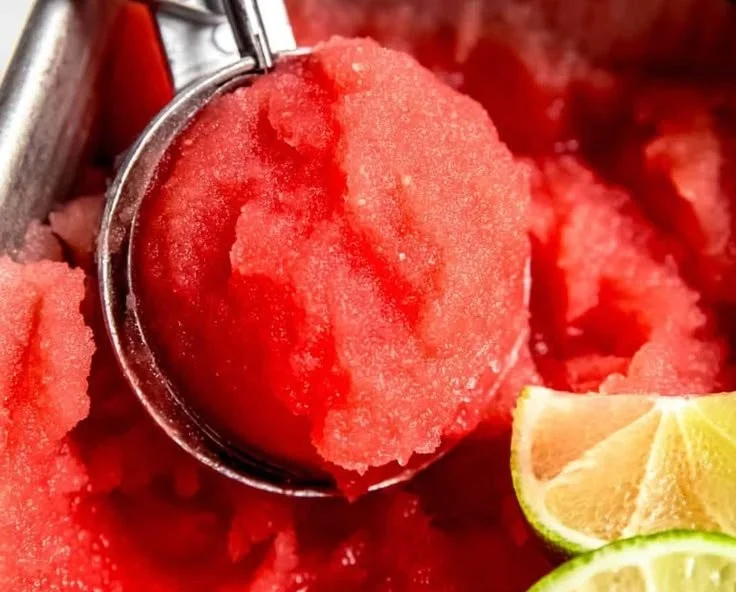 Delicious homemade watermelon sorbet served in a bowl with fresh mint leaves
