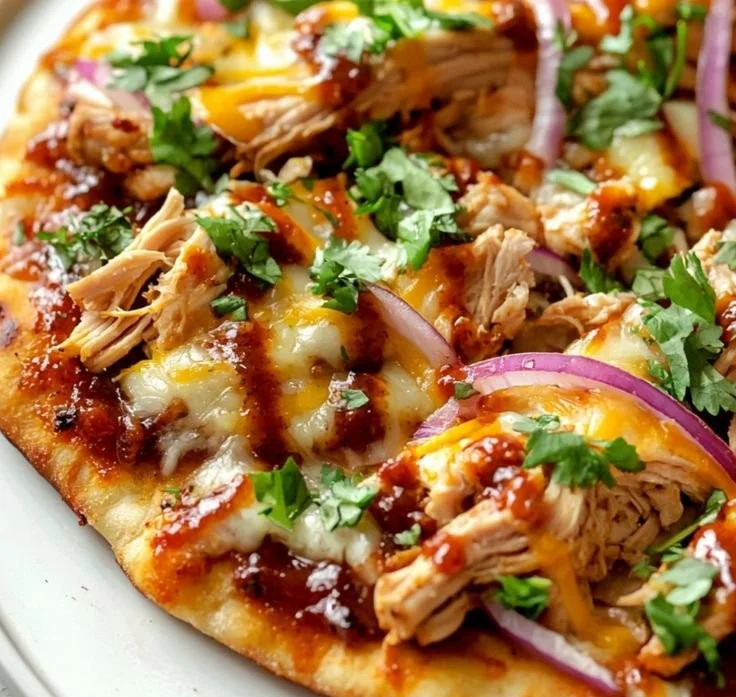BBQ chicken flatbread topped with fresh ingredients and garnished beautifully